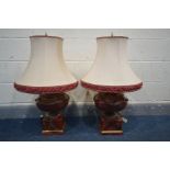 A MATCHING PAIR OF RED MARBLE EFFECT TABLE LAMPS with fabric shades