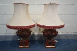 A MATCHING PAIR OF RED MARBLE EFFECT TABLE LAMPS with fabric shades