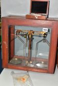 A SET OF BRASS SCIENTIFIC/APOTHECARY BALANCE SCALES BY ELLIOTS OF LIVERPOOL, housed in a mahogany