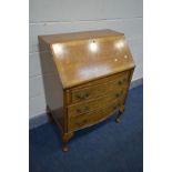 A REPRODUCTION BURR WALNUT BUREAU, with a fitted interior, three drawers, on cabriole legs, width