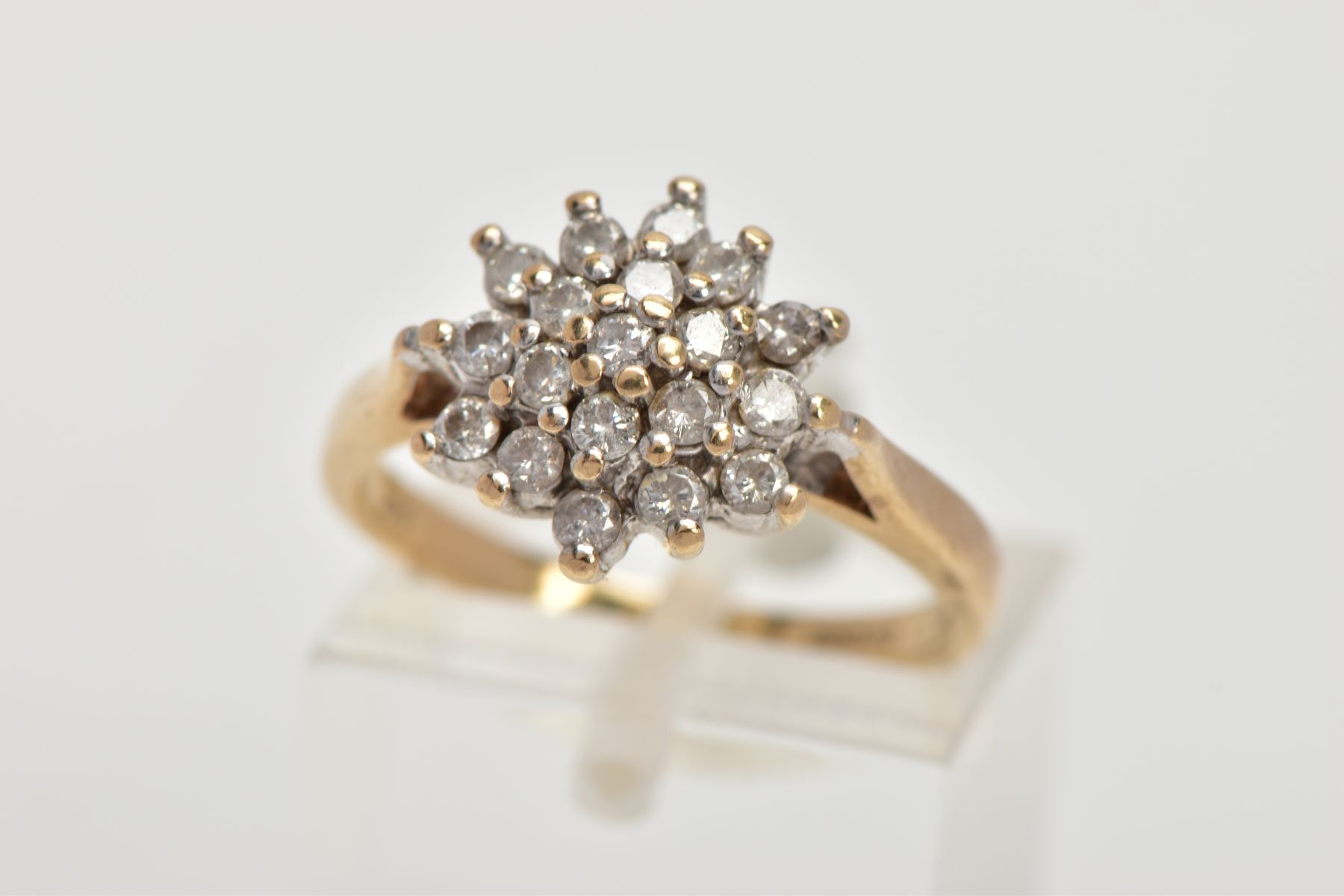 A 9CT GOLD DIAMOND CLUSTER RING, the cluster designed with claw set, round brilliant cut diamonds,