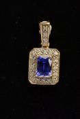 AN 18CT GOLD TANZANITE AND DIAMOND PENDANT, of a rectangular form, designed with a four claw set,