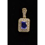 AN 18CT GOLD TANZANITE AND DIAMOND PENDANT, of a rectangular form, designed with a four claw set,