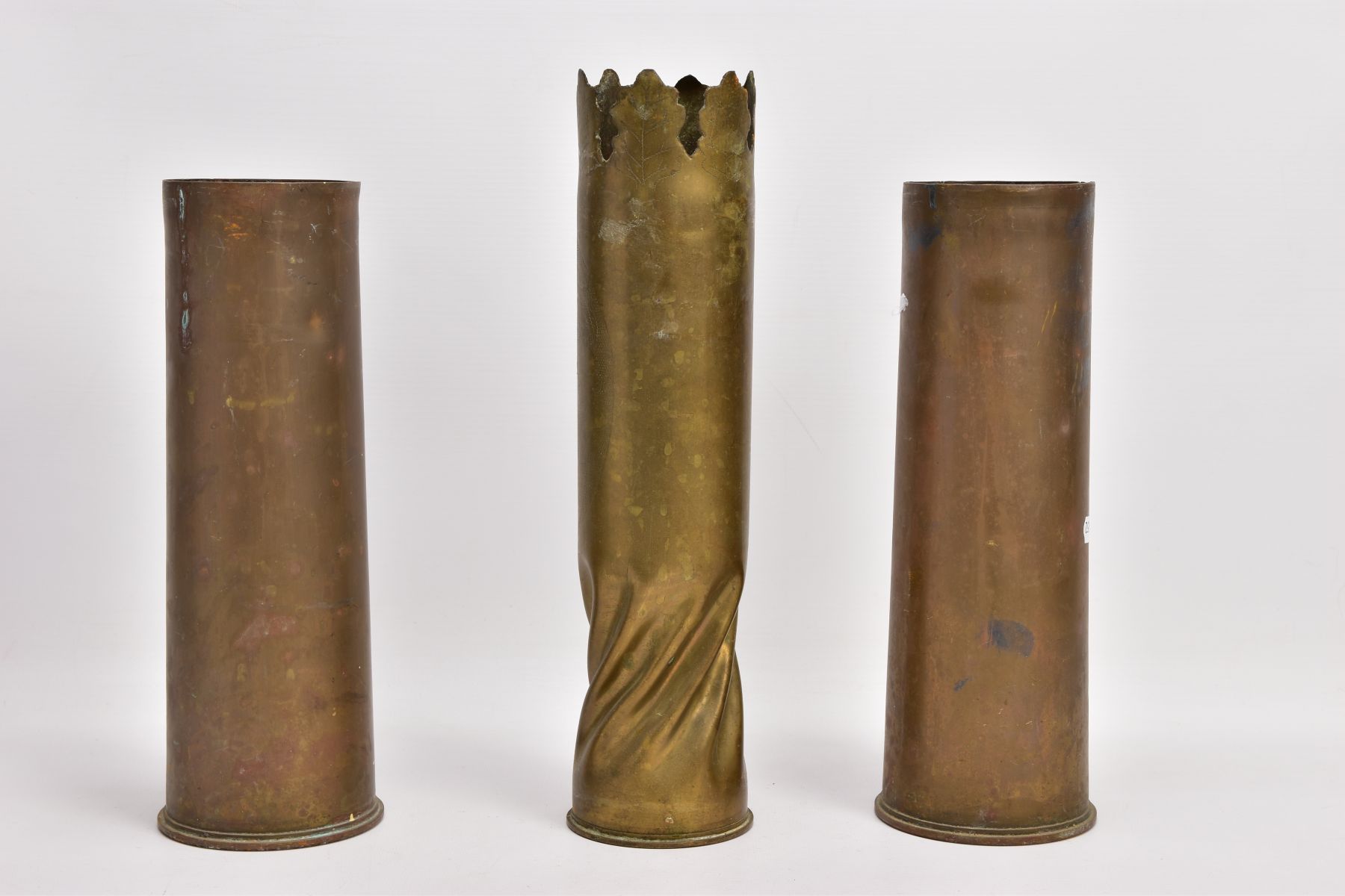 THREE WWI ERA SHELL CASES, one in Trench Art form, hammered giving the effect of being twisted,