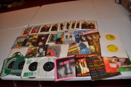 A SINGLES CASE CONTAINING APPROX THIRTY FIVE SINGLES AND EPs by The Beatles and the Rolling Stones