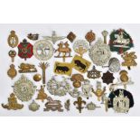 A BOX CONTAINING OVER THIRTY MILITARY CAP BADGES AND INSIGNIA, to include Argyll & Sutherland, KOSB,