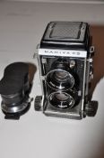 A MAMIYA CS PROFESSIONAL TLR CAMERA fitted with a pair of 80mm lenses and a pair of 135mm lenses