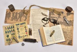 A BOX CONTAINING MILITARY ITEMS, including five whistles, some maker marked, penknife, inert
