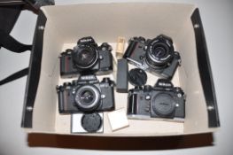 A TRAY CONTAING FOUR NIKON F3 FILM SLR CAMERA two fitted with 50mm f 1.8 lenses, one with a 35-