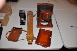 A THORNTON PICKARD IMPERIAL MAHOGANY AND BRASS PLATE CAMERA with plate and oak tripod along with a
