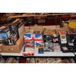 THREE TRAYS CONTAINING VINTAGE GAMING CONSOLES including a boxed Grandstand Astro Wars, a Tomytronic