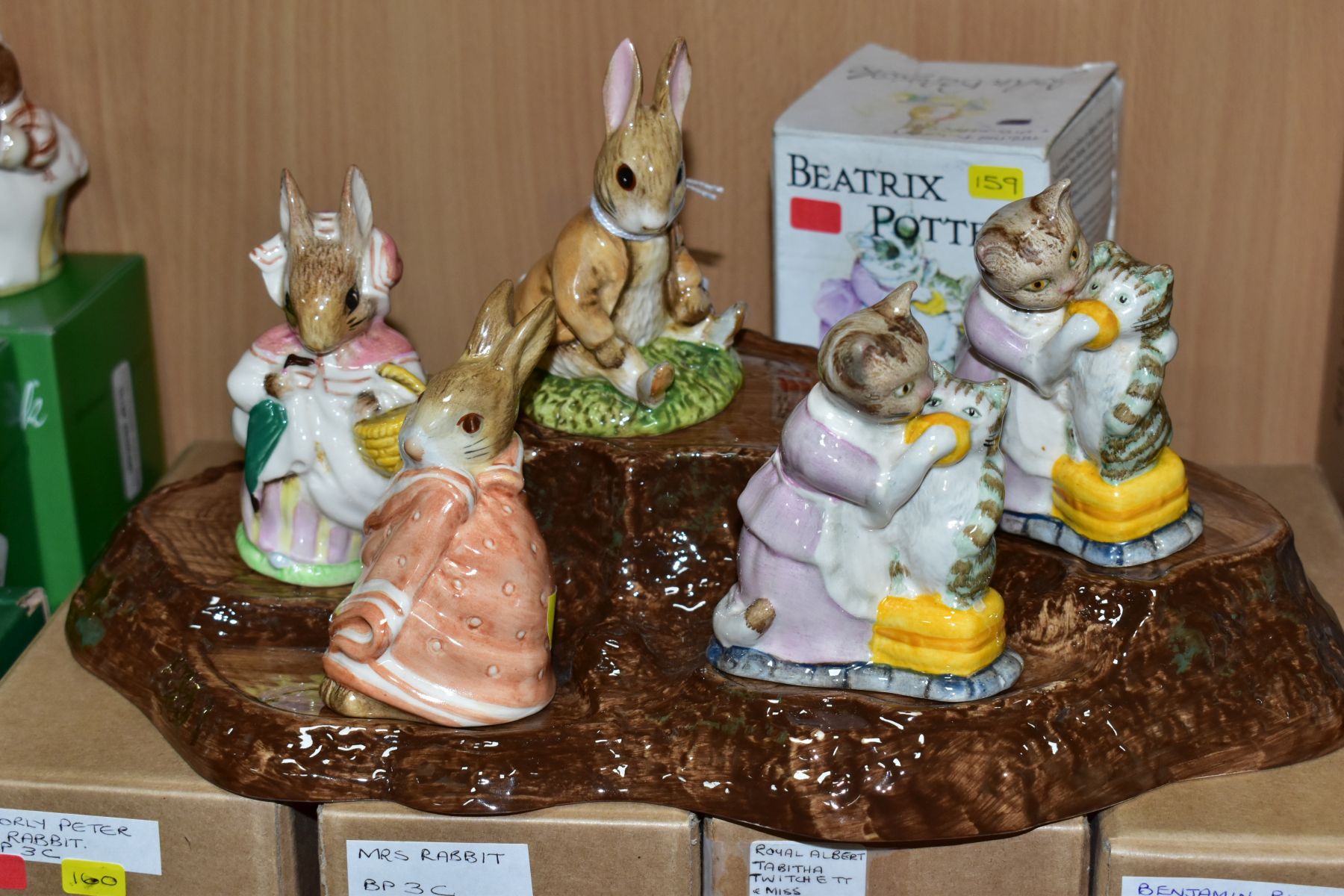 FIVE BESWICK BEATRIX POTTER FIGURES BP3C AND A BESWICK DISPLAY STAND No 2295, comprising Benjamin