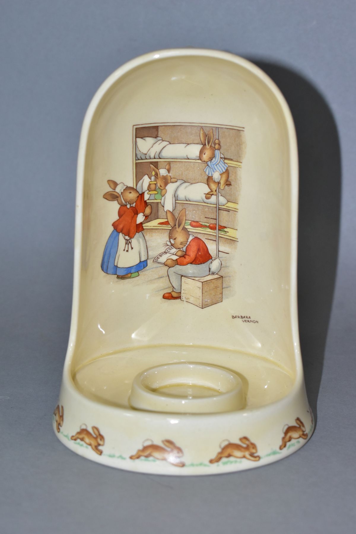 A ROYAL DOULTON BUNNYKINS EARTHENWARE CANDLE HOLDER, designed by Barbara Vernon, Bedtime In Bunks (