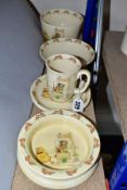 SIX PIECES OF ROYAL DOULTON BUNNYKINS EARTHENWARE TABLES WARES OF CHICKEN PULLING CART, DESIGNED