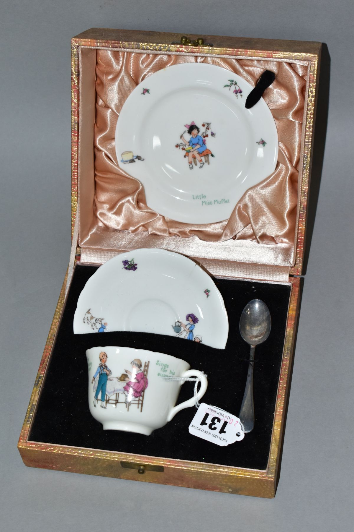 A CASED ROYAL DOULTON CHINA NURSERY RHYMES L SERIES WARE TRIO AND SILVER PLATED TEASPOON, the