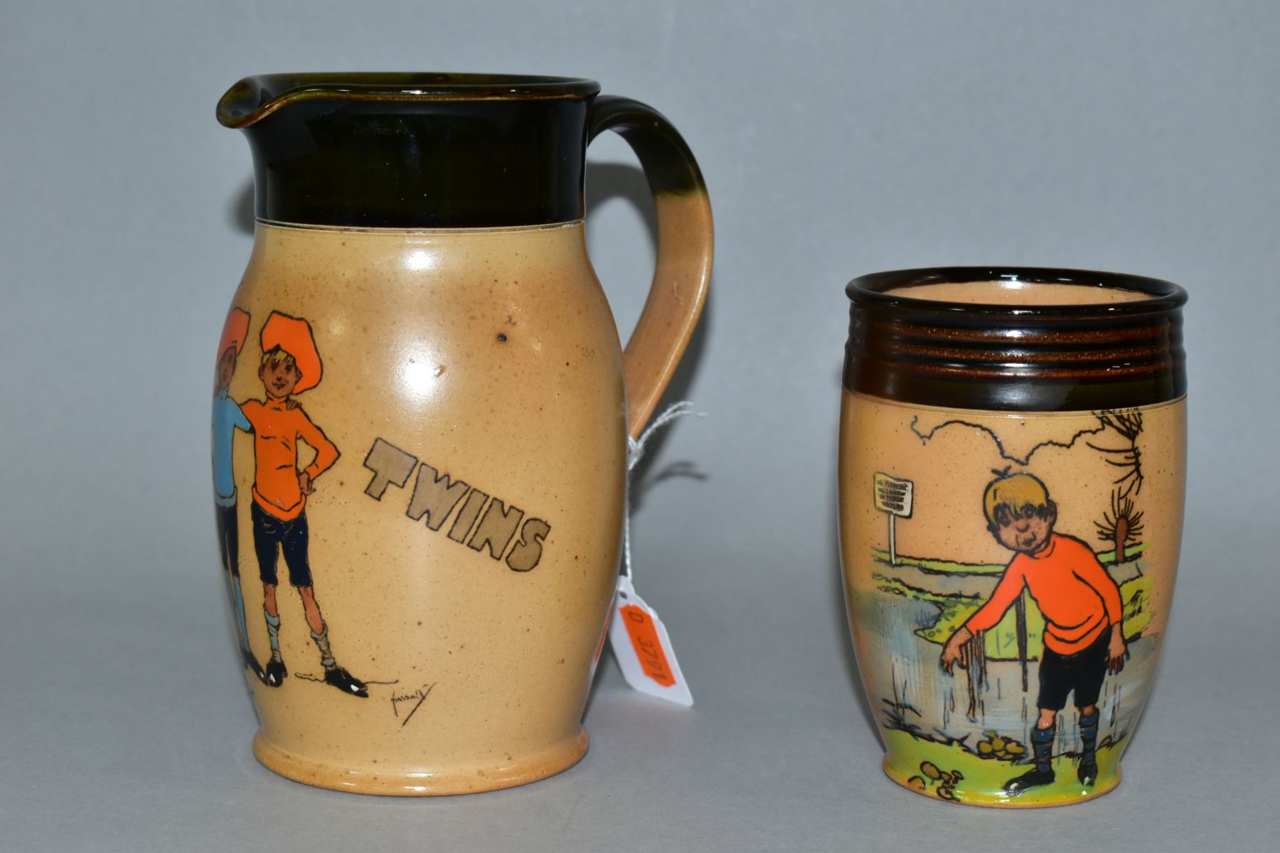 TWO EARLY 20TH CENTURY ROYAL DOULTON LAMBERTH STONEWARE ITEMS FROM THE TWINS SERIES WARE by John