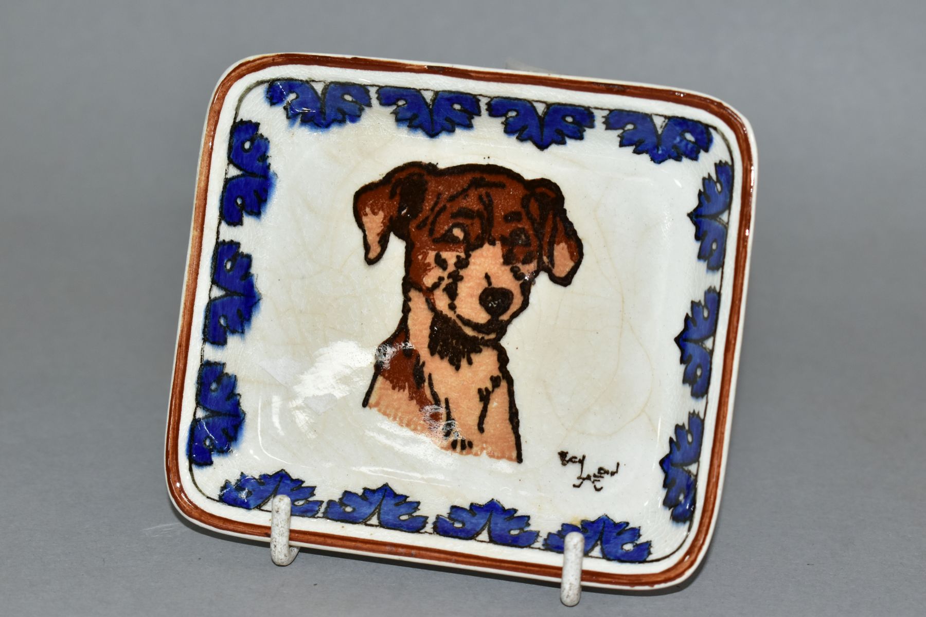 A ROYAL DOULTON CECIL ALDIN DOGS SERIES WARE PIN TRAY, depicting dog's head with an acanthus border,
