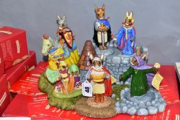 A SET OF SEVEN BOXED ROYAL DOULTON BUNNYKINS FIGURES AND STAND FROM THE ARTHURIAN LEGENDS