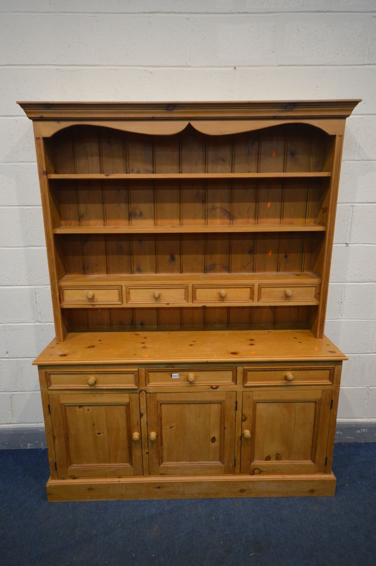 A PINE DRESSER with an arrangement of drawers above three cupboard doors, width 153cm x depth 41cm x