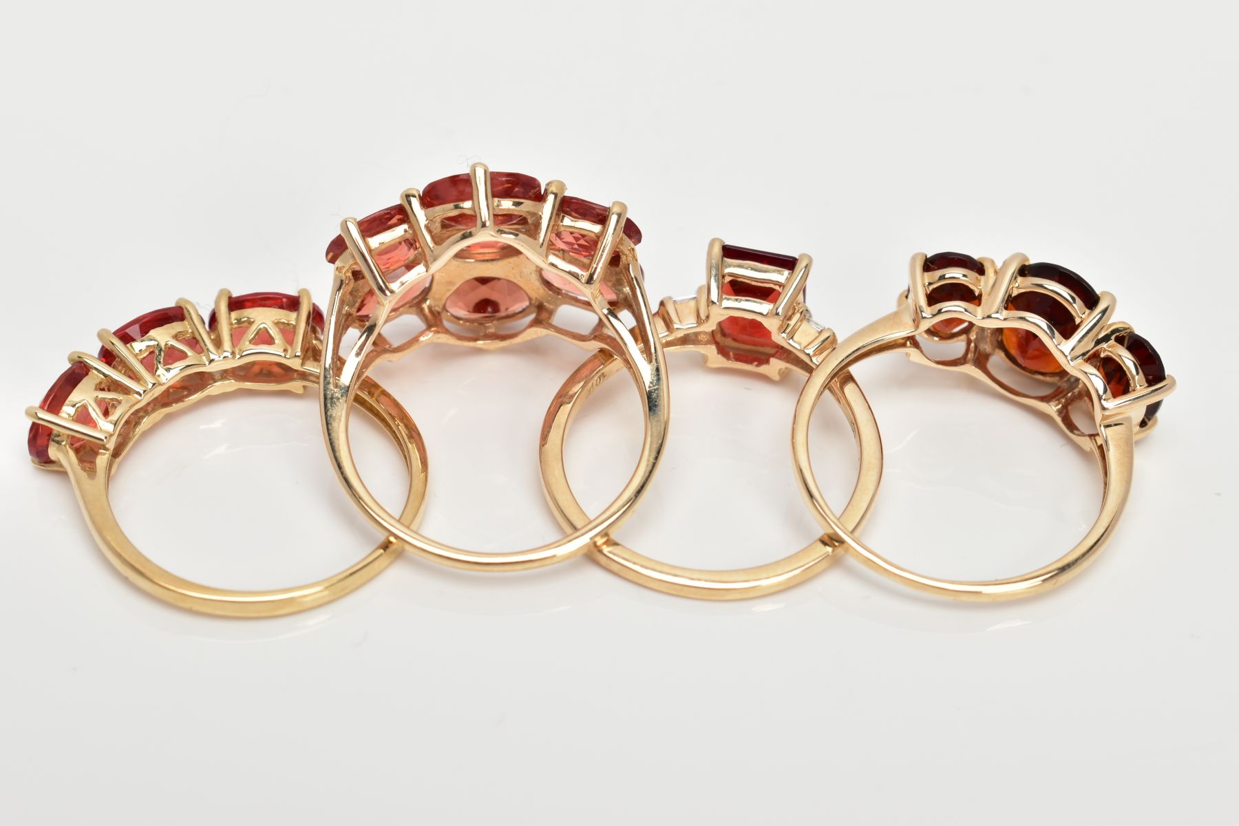 FOUR 9CT GOLD GEM SET RINGS, set with orange and red gemstones possibly Andesine, each with a 9ct - Image 3 of 3