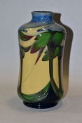 A MOORCROFT POTTERY TRIAL VASE, the waisted vase tube line decorated with stylised trees,