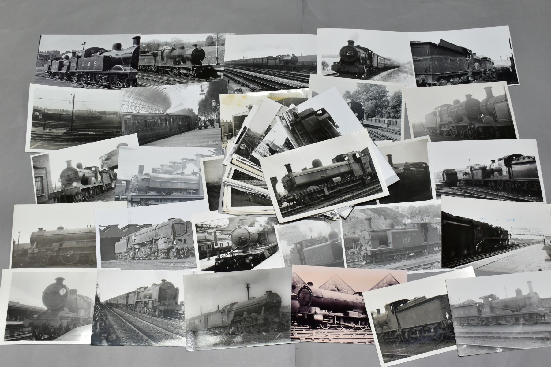 A QUANTITY OF ASSORTED BLACK AND WHITE POSTCARD SIZE PHOTOGRAPHS OF BRITISH STEAM LOCOMOTIVES,