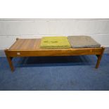 A 1960'S TEAK BENCH/COFFEE TABLE, the triple reversable inserts with cushion seat pads upholstered