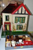 A WOODEN DOLLS HOUSE, in the Tri-ang Tudorbethan style, front opening to reveal three rooms and an