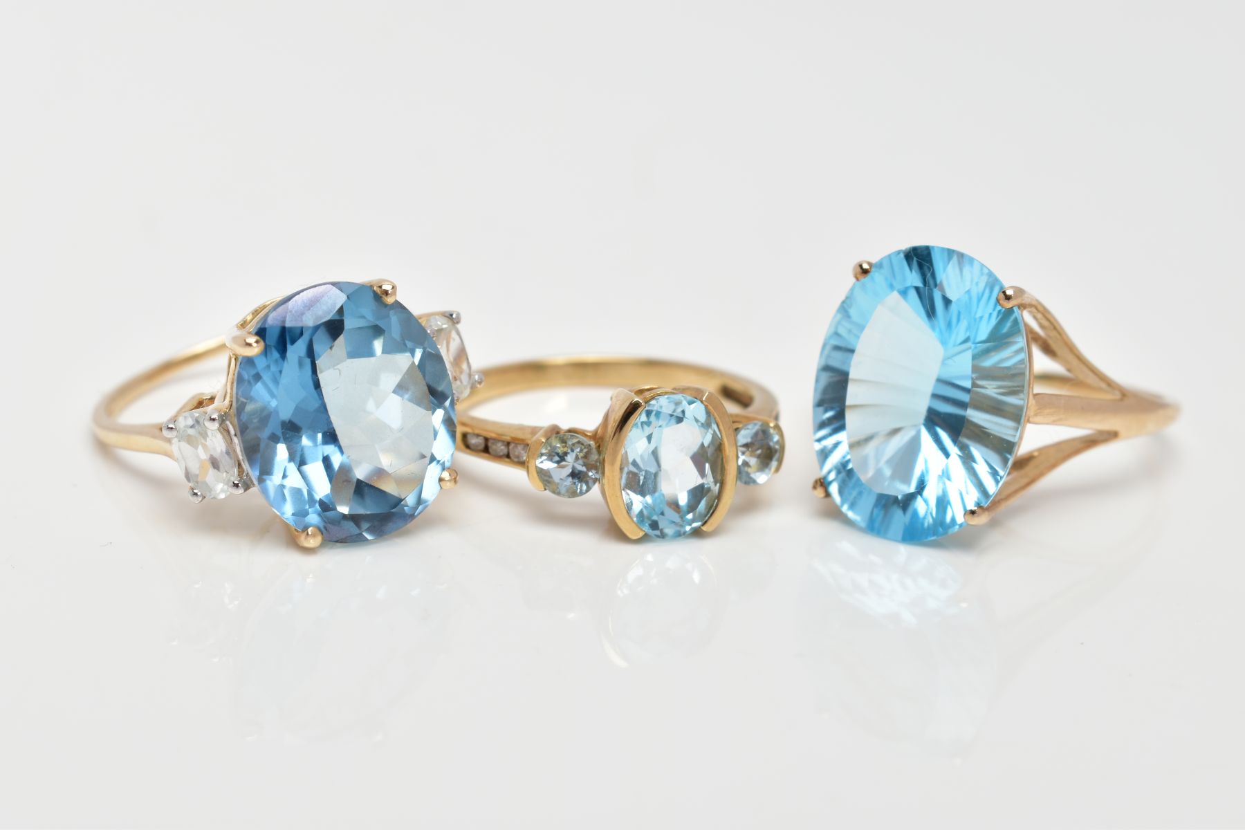 THREE 9CT GOLD DRESS RINGS, the first set with a central oval cut blue topaz, flanked with - Image 2 of 3