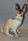 A WINSTANLEY POTTERY CREAM AND MOTTLED BROWN FIGURE OF A SEATED HARE, glass eyes, painted marks to