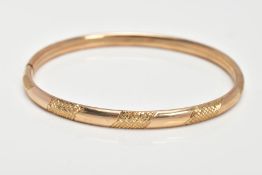 A 9CT GOLD HOLLOW BANGLE, textured design, integrated clasp, hallmarked 9ct gold Birmingham