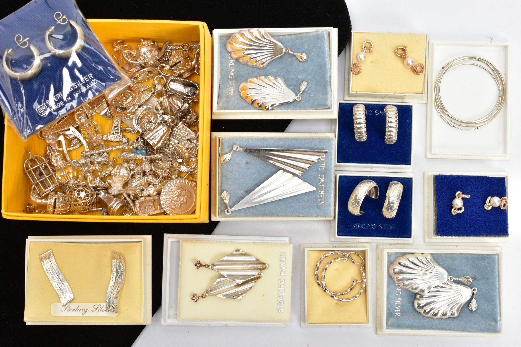 TWELVE BOXED PAIRS OF WHITE METAL EARRINGS, AND A BOX OF ASSORTED LOOSE CHARMS, earrings of