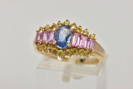 A 9CT GOLD GEM SET DRESS RING, designed with a central four claw set, oval cut blue stone assessed