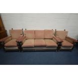 AN EARLY 20TH CENTURY CARVED OAK AND UPHOLSTERED THREE PIECE LOUNGE SUITE, with acorn armrests,