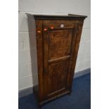 AN OAK PANELLED SINGLE DOOR CUPBOARD, incorporating older timbers, on later feet, width 61cm x depth