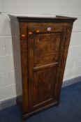 AN OAK PANELLED SINGLE DOOR CUPBOARD, incorporating older timbers, on later feet, width 61cm x depth