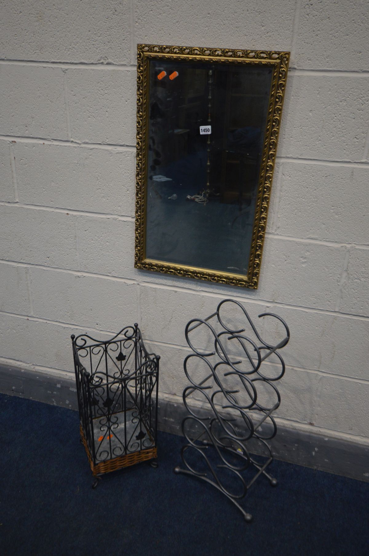 A METAL AND WICKER UMBRELLA STAND, a metal wine rack, and a gilt frame wall mirror (3)