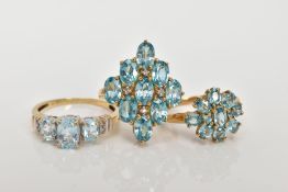 THREE 9CT GOLD BLUE TOPAZ DRESS RINGS, two designed as clusters, ring sizes O, hallmarked 9ct gold