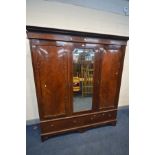 AN EARLY 20TH CENTURY MAHOGANY TRIPLE DOOR WARDROBE, with two long drawers (condition:- scratches,