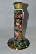 A WILLIAM MOORCROFT SPANISH PATTERN CANDLESTICK, of ogee inverted trumpet form, mottled green/blue