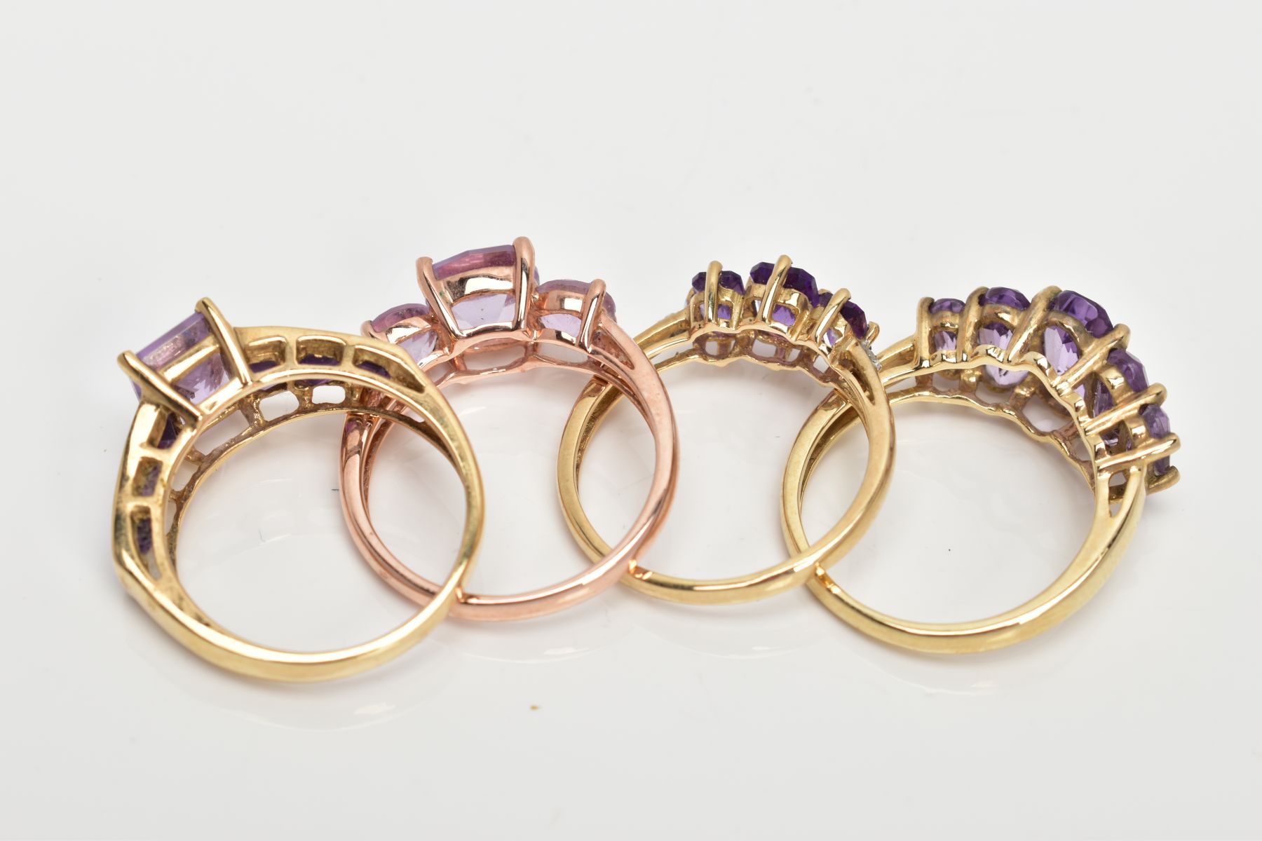 FOUR 9CT GOLD AMETHYST DRESS RINGS, three yellow gold and one rose gold, each set with vary cut - Image 3 of 3