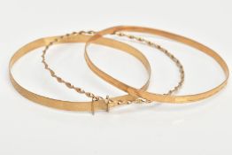 A 9CT BANGLE AND TWO YELLOW METAL BANGLES, the extendable bangle with a textured design,