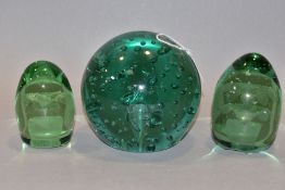 THREE VICTORIAN GREEN GLASS DUMP WEIGHTS, comprising a large spherical weight with controlled bubble