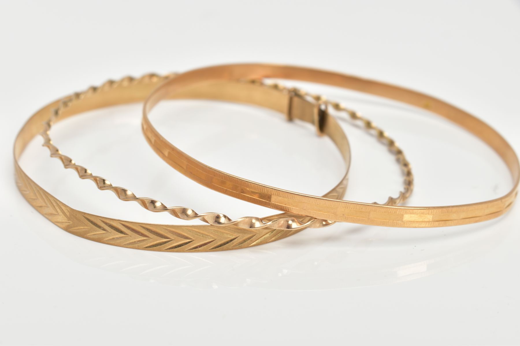 A 9CT BANGLE AND TWO YELLOW METAL BANGLES, the extendable bangle with a textured design, - Image 2 of 2