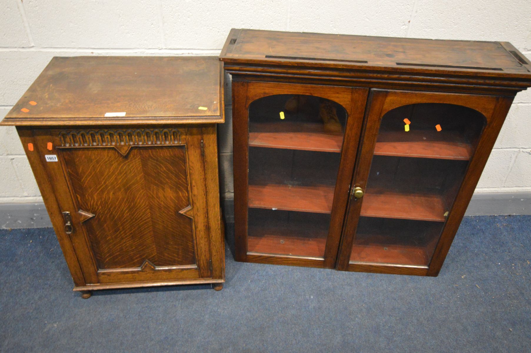 AN EARLY 20TH CENTURY OAK SINGLE PANELLED DOOR CABINET with a single shelf, on bun feet width 61cm x