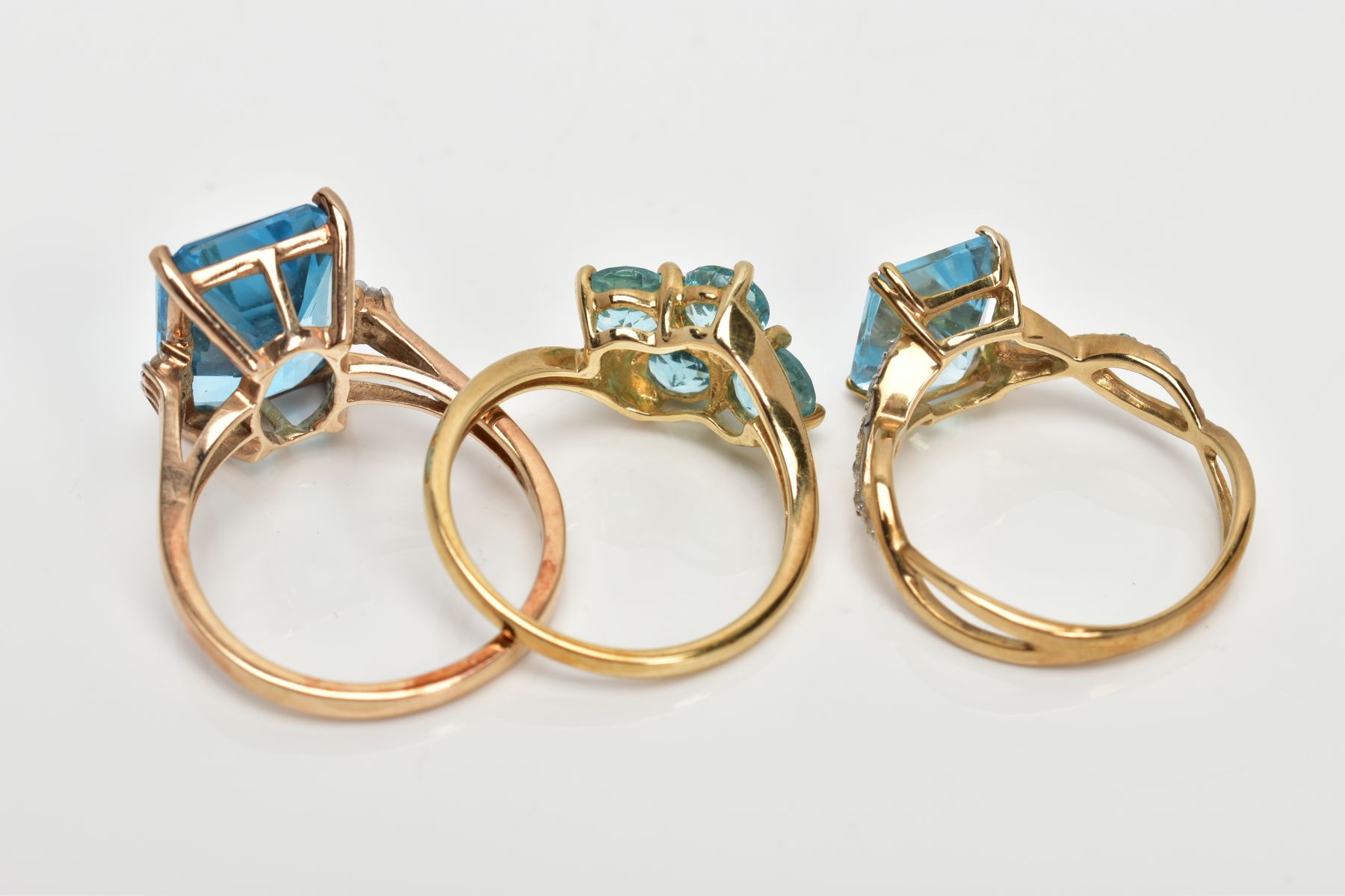 THREE 9CT GOLD TOPAZ DRESS RINGS, the first designed with a rectangular cut blue topaz, flanked with - Image 3 of 3