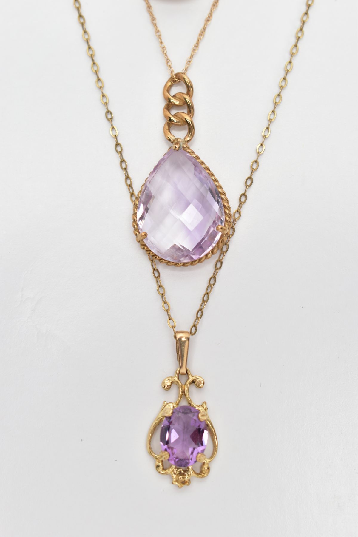 THREE AMETHYST PENDANT NECKLACES AND A CARVED AMETHYST PENDANT, the first a faceted pear cut - Image 2 of 3