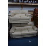 A TWO PIECE CREAM LEATHER SUITE comprising a three seat settee, width 195cm and a two seat settee,