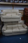 A TWO PIECE CREAM LEATHER SUITE comprising a three seat settee, width 195cm and a two seat settee,