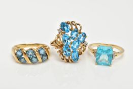 THREE 9CT GOLD TOPAZ DRESS RINGS, the first an openwork cluster set with seven oval cut blue